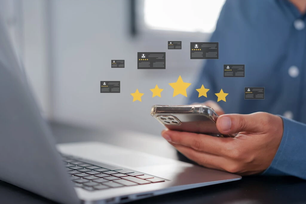 Man leaving 5 star review on phone after good website experience.